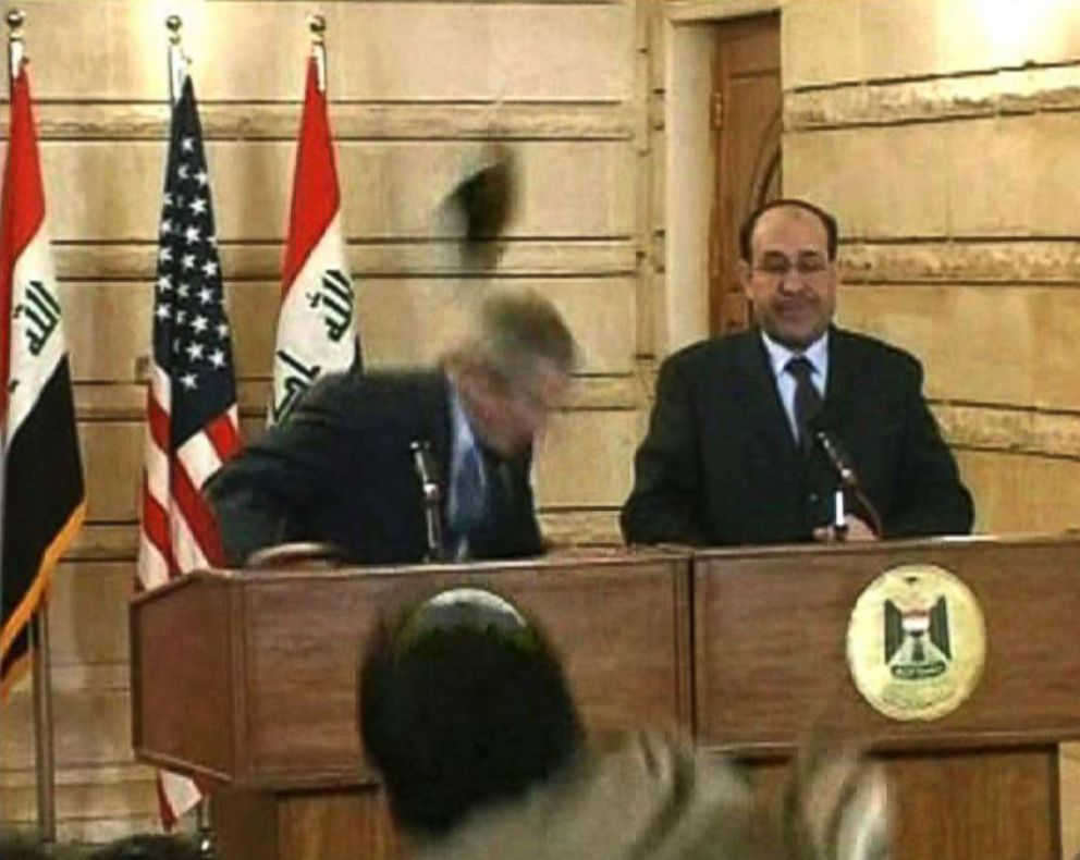 A picture of a shoe being thrown at George W. Bush.