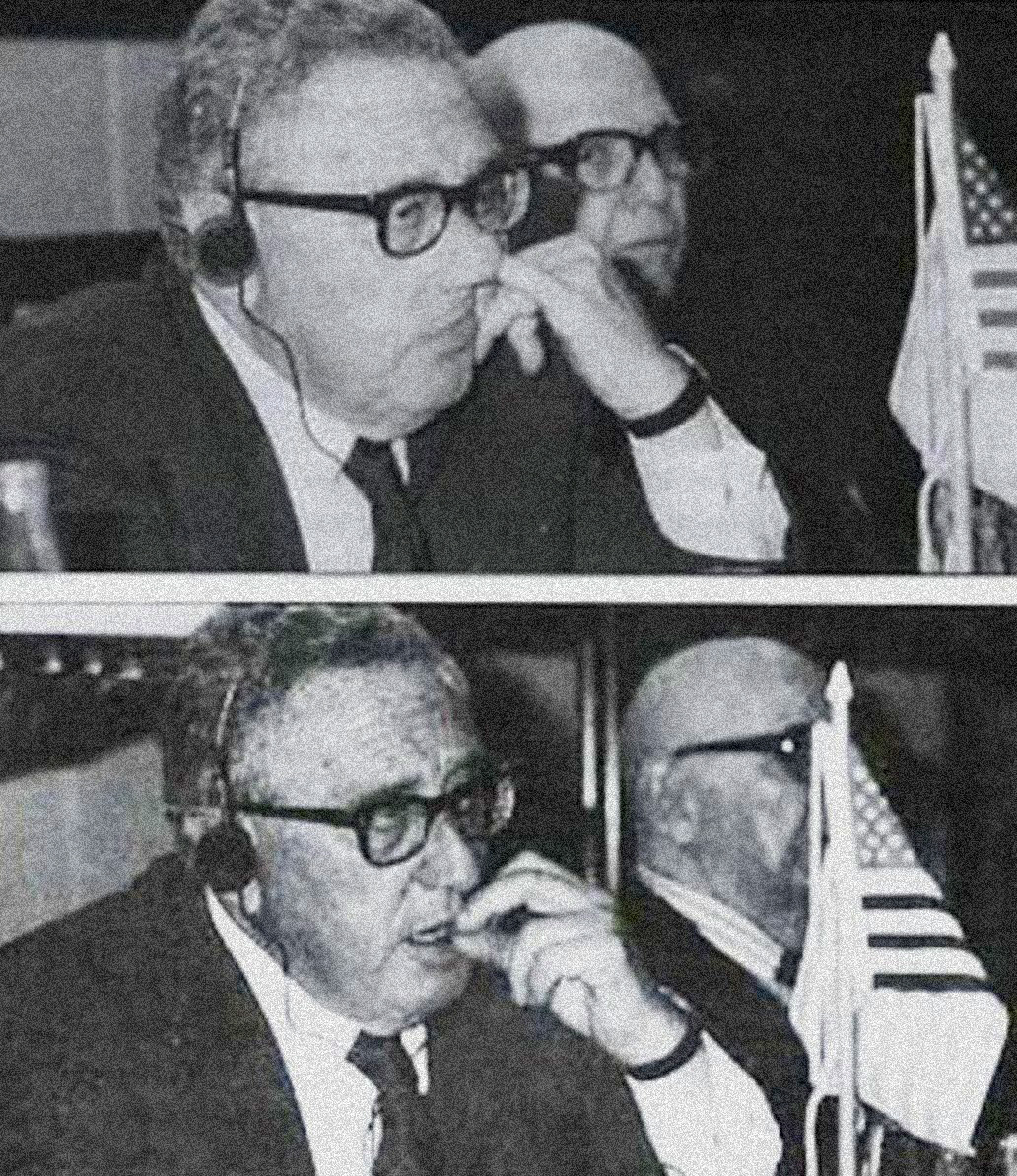 A picture of Henry Kissinger picking and eating his boogers.